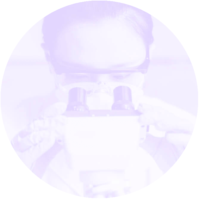 Scientist looking into a microscope